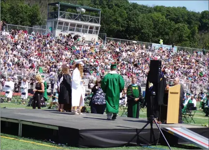  ?? BOB KEELER — MEDIANEWS GROUP ?? Pennridge graduates cross the stage as their name is announced during the June 15graduati­on ceremony.