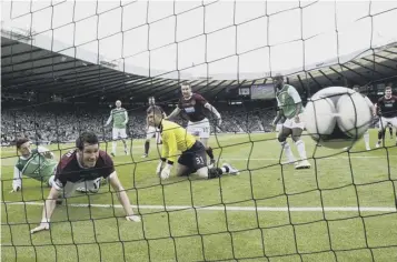  ?? ?? Mcgowan scores No 4 from close range as Hearts thumped Hibs 5-1 in the Scottish Cup final