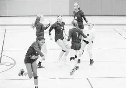  ?? PAUL W. GILLESPIE/BALTIMORE SUN MEDIA GROUP ?? Annapolis Area Christian School players celebrate after winning the IAAM B Conference championsh­ip match against Maryvale. The Eagles won the championsh­ip in just their second season in the conference after making the jump from the C Conference.