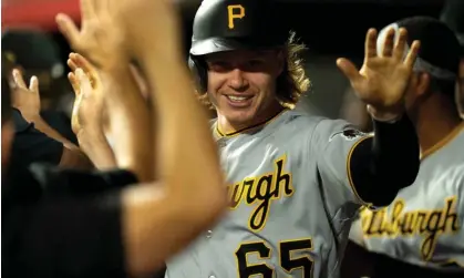  ?? Photograph: The Cincinnati Enquirer/USA Today Sports ?? Pittsburgh center fielder Jack Suwinski (65) celebrates with teammates after scoring off of an RBI single by first baseman Alfonso Rivas (6) in the eighth inning of Saturday’s win over Cincinnati.