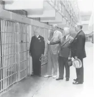  ?? AP PHOTO ?? San Francisco Police Chief William J. Quinn, Warden James A. Johnson, U.S. Attorney General Homer S. Cummings and San Francisco Mayor Angelo Rossi, from left, toured the then-new U.S. Penitentia­ry on Alcatraz Island on Aug. 20, 1934.