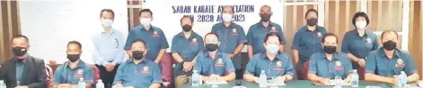  ?? ?? Jake (seated third right) with the Sabah Karate Associatio­n 2021-2022 office bearers.