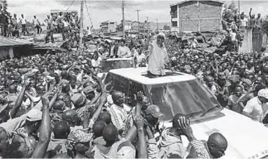  ??  ?? Opposition leader Raila Odinga is greet by thousands of his supporters as he drives through Kawangare on Sunday. (Photo: EPA)