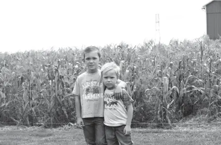  ?? JULIE VENNITTI BOTOS ?? Owen Reinsel, 8, with the help of his brother, Chase, 5, grows his own crops, including corn, peppers, flowers, herbs and pumpkins in the yard of his Alliance home.