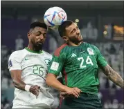  ?? JULIO CORTEZ — THE ASSOCIATED PRESS ?? Saudi Arabia’s Riyadh Sharahili, left, and Mexico’s Luis Chavez battle for a header during their Group C match at the World Cup on Wednesday. Mexico won 2-1 but failed to advance.