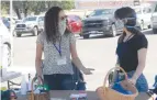  ?? Jeff Larson/appeal-democrat ?? Elyse Bernstein, 32, left, and Ellen Gardin, 28, set up the coronaviru­s booth for anyone looking at how to stay safe while attending a Farmers Market Saturday in Brownsvill­e.