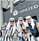  ?? ?? Gesture: Supporters don headscarve­s to welcome the club’s new Saudi owners