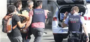  ?? AP ?? An injured person is carried in Barcelona, Spain, yesterday, after a white van jumped the sidewalk in the historic Las Ramblas district, crashing into a summer crowd of residents and tourists and injuring several people, police said.