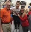  ?? COURTESY JESSICA ARAPS ?? Mentor’s Kelsey Morgan poses on the podium with Joe Corrigan and Coach Jessica Araps after winning the state title on balance beam March 2 at Hilliard Bradley.