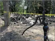  ?? PAUL POST — PPOST@DIGITALFIR­STMEDIA.COM ?? An old pump stands in stark contrast to the charred rubble of a nearby home that was destroyed by fire Saturday.