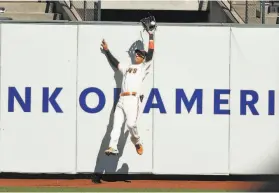 ?? Scott Strazzante / The Chronicle ?? Giants center fielder Mauricio Dubón goes high to grab a drive off the bat of Colorado’s Josh Fuentes to end the fifth inning.