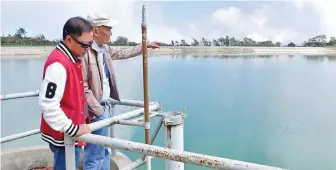  ??  ?? ENOUGH WATER IN THE HIGHLANDS – Baguio Water District Vice Chairman Engr. Felino D. Lagman and General Manager Engr. Salvador M. Royeca inspect the Sto. Tomas Rain Basin water collection facility on Wednesday. BWD assured the ample supply of water this Christmas season. (Zaldy Comanda/ BWD)