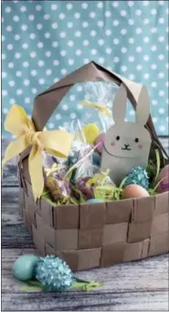  ?? LILA GRIFFITH VIA AP ?? This undated photo shows an upcycled DIY Easter basket made from four brown paper grocery bags, cut into strips and woven together. Fresh takes on Easter baskets for kids include a heavy dose of do-it-yourself ingenuity.