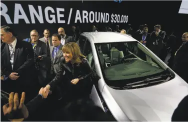  ?? Gregory Bull / Associated Press 2016 ?? General Motors CEO Mary Barra stands next to the Chevrolet Bolt at 2016’s CES trade show in Las Vegas.