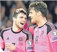  ??  ?? Andy Robertson celebrates with Chris Martin