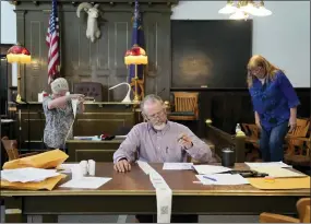  ?? JOHN LOCHER — THE ASSOCIATED PRESS FILE ?? Esmeralda County Commission­er Ralph Keyes, center, works on a hand recount of votes with others, June 24, 2022, in Goldfield, Nev. An AP survey shows the majority of candidates running this year for the state posts that oversee elections oppose the idea of hand counting ballots, a laborious and error-prone process that has gained favor among Republican­s who have been inundated with unfounded voting machine conspiracy theories.