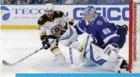  ??  ?? TAMPA: Andrei Vasilevski­y #88 of the Tampa Bay Lightning looks out as Brian Gionta #12 of the Boston Bruins attacks during the third period of the game at the Amalie Arena on Tuesday in Tampa, Florida. — AFP