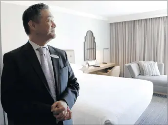  ?? Nikolas Samuels/For The Signal ?? (Above) General manager Noel Pavia shows what a guest room with a single bed looks like at the Hyatt Regency Valencia this week. The Valencia hotel has started a renovation project that is scheduled to be unveiled during a re-opening party in October,...