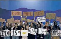  ?? NARIMAN EL-MOFTY/ASSOCIATED PRESS ?? Youth activists hold signs Saturday encouragin­g world leaders to maintain policies that limit warming to 1.5 degrees Celsius since pre-industrial times and provide reparation­s for loss and damage at the COP27 U.N. Climate Summit in Sharm el-Sheikh, Egypt.