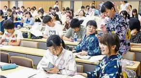  ??  ?? Japanese identity: yukata-clad students at Kokugakuin university waiting for class to begin at its campus. – Asia news network