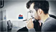  ??  ?? Controvers­ial joint: Antonin Cohen tokes on a KanaVape in his Paris office.