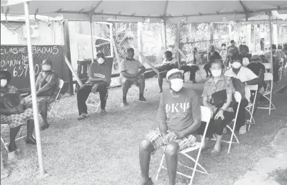  ??  ?? Pensioners at Bourda Post Office strategica­lly seated to maintain physical distance earlier this month