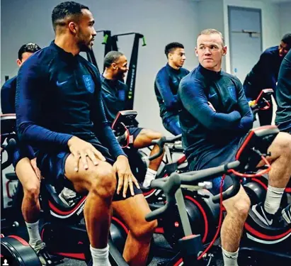  ??  ?? Cycle of life: Rooney (right) warms up with the England squad on his internatio­nal return REX