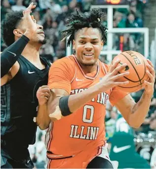  ?? CARLOS OSORIO/AP ?? Illinois guard Terrence Shannon Jr. drives against Michigan State’s Jaden Akins during the first half Saturday in East Lansing, Mich. Shannon scored 28 points in the Illini’s 88-80 loss.