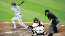  ?? PATRICK SEMANSKY/THE ASSOCIATED PRESS ?? Toronto Blue Jays’ Kendrys Morales, left, had his hitting shoes on Thursday night, banging out three homers and knocking in seven runs in an 11-8 Jays victory.