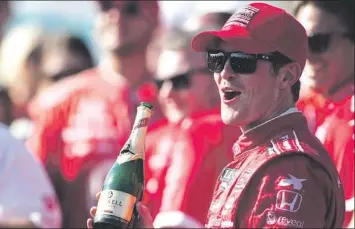  ?? — Photo by The Canadian Press ?? It’s not just the champagne that has Scott Dixon feeling bubbly as he stands in victory circle after winning the Toronto Indy on Sunday. It was the second win in Toronto in as many days for Dixon.