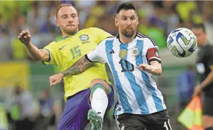  ?? BRUNA PRADO/AP ?? Argentina’s Lionel Messi, right, and Brazil’s Carlos Augusto battle for the ball during a World Cup qualifier Nov. 21 in Rio de Janeiro.