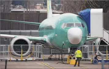  ?? Ruth Fremson / The New York Times ?? A new, unpainted 737 MAX 9 sits at Boeing’s plant in Renton, Wash., Monday. The stakes for Boeing are high, with 4,600 pending orders that promise to bring in hundreds of billions of dollars.