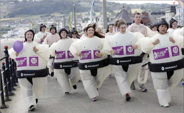  ??  ?? Action from the Purple House Sumo Run on Bray Seafront.