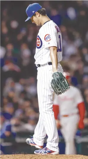  ?? KAMIL KRZACZYNSK­I/AP ?? Yu Darvish reacts after giving up J.T. Realmuto’s RBI single in the sixth inning, before Cesar Hernandez tripled to drive in two more runs and mar Darvish’s solid outing.