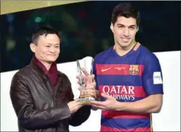 ?? AFP ?? FC Barcelona player Luis Suarez (R) receives the FIFA Club World Cup from Jack Ma (L), chairman of Alibaba Group, China’s e-commerce giant, on December 20, 2015. Barcelona beat Yokohama, suburban Tokyo, to clinch the title last year.