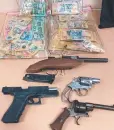  ?? ?? Seized guns and cash. Picture: Tasmania Police