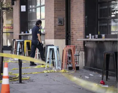  ?? AP ?? ‘NO REGARD FOR HUMAN LIFE’: Investigat­ors process the scene of a shooting at Seventh Street Truck Park in St. Paul, Minn., on Sunday.