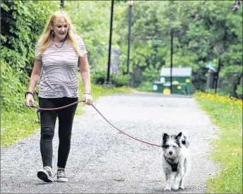  ?? SUEANN MUSICK/THE NEWS ?? Megan MacKay and Sunee enjoy daily walks on the Samson Trail, but she said it’s getting more and more common to see dogs that are off leash.