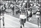  ?? Associated Press ?? SMITH raises his arms in triumph after winning the 200 meters, an event that led to the podium protest.