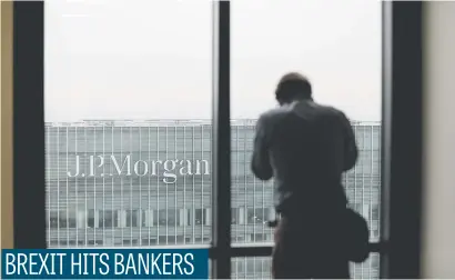  ?? Picture: Bloomberg ?? A man looks across to the offices of JPMorgan Chase & Co in London yesterday. JPMorgan is to move hundreds of London-based bankers to Dublin, Frankfurt and Luxembourg after Brexit, the firm says.