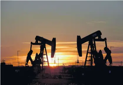  ?? NICK OXFORD/REUTERS ?? Pump jacks operate at sunset in an oil field in Midland, Texas, last year.