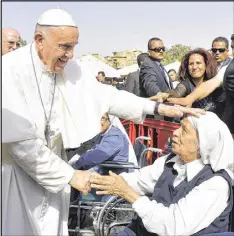  ?? L’OSSERVATOR­E ROMANO VIA ASSOCIATED PRESS ?? Pope Francis greets a nun during a meeting with the clergy and religious in Cairo on Saturday. The pope celebrated Mass before about 15,000 in a soccer stadium.