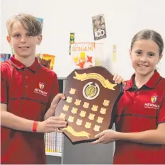  ?? ?? Riley Pols and Carmen Matthews hold the Cross Country Shield for Maroon House after the presentati­on ceremony at the Newman College library. Pictures: Jai Penistone