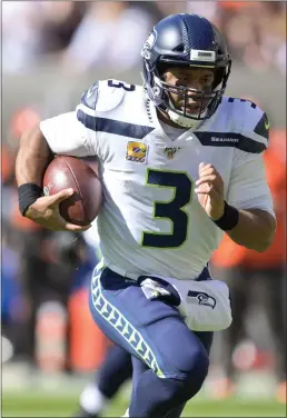  ?? DAVID RICHARD — THE ASSOCIATED PRESS ?? Seattle Seahawks quarterbac­k Russell Wilson rushes for a 16-yard touchdown during the first half of Sunday’s 32-28victory vs. Cleveland.