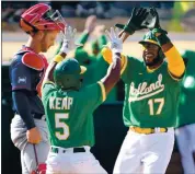  ?? DOUG DURAN – STAFF PHOTOGRAPH­ER ?? The A’s Tony Kemp, left, and Elvis Andrus celebrate after scoring the tying and winning runs, respective­ly.