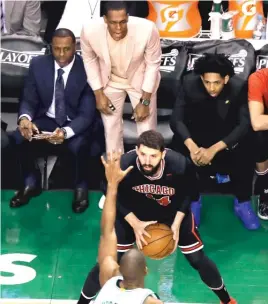  ??  ?? Bulls point guard Rajon Rondo yells encouragem­ent from the bench to forward Nikola Mirotic in the first quarter of Game 5 on Wednesday night.
| CHARLES KRUPA/ AP