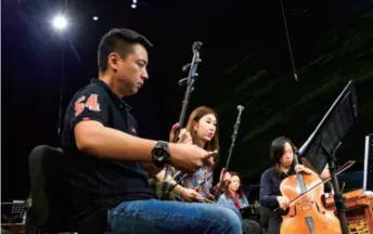  ??  ?? The Macao Chinese Orchestra, which features both traditiona­l Chinese and Western instrument­s, holds a rehearsal on November 3