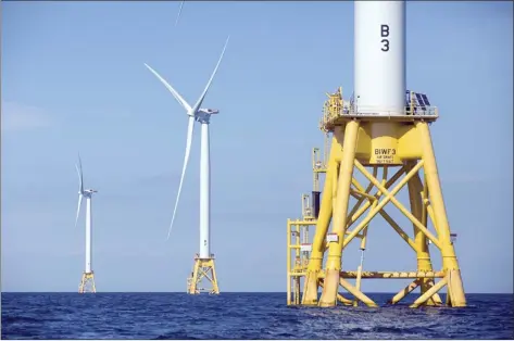  ?? AP file photo ?? Deepwater Wind's turbines stand in the water off Block Island, R.I., one of only two operationa­l U.S. wind farms in 2021. Members of the wind power industry and clean energy advocates are hoping that President Joe Biden's administra­tion can transform the country into a leader in offshore wind power.