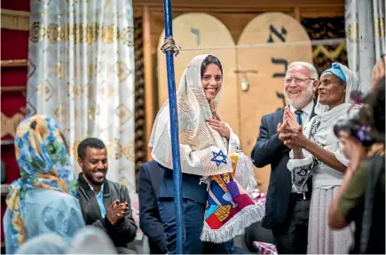  ?? PHOTO: AP ?? Israel’s Justice Minister Ayelet Shaked receives traditiona­l clothes from members of Ethiopia’s Jewish community, during a visit to a synagogue in Addis Ababa, Ethiopia.