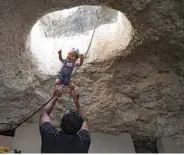  ??  ?? Ahmed Amarneh throws his daughter beneath a skylight hole as they play together at his home, built in cave in the village of Farasin.